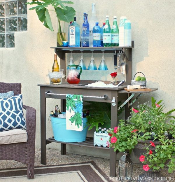 Inexpensive potting bench turned into an outdoor bar and beverage station for entertaining. The Creativity Exchange